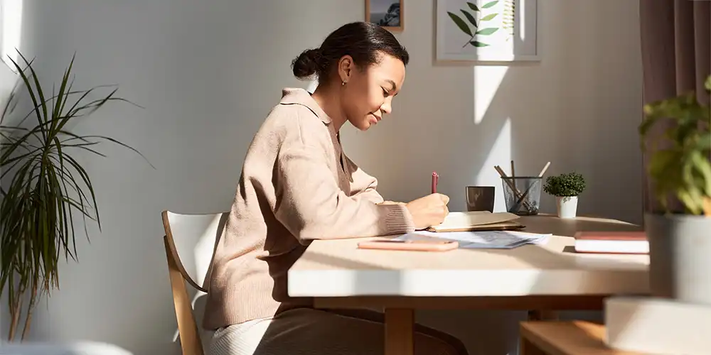 woman journaling at desk