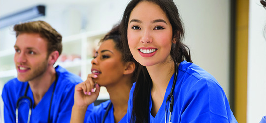 three health care students in classroom