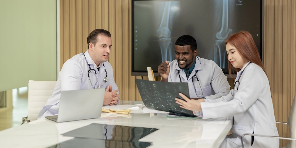 surgeons reviewing knee x-ray