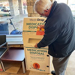 man using medical drop off station
