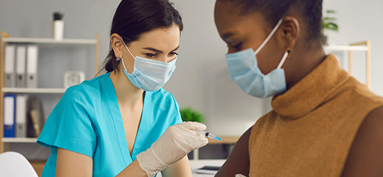 nurse giving measles vaccine shot