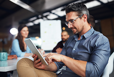 man reading on tablet