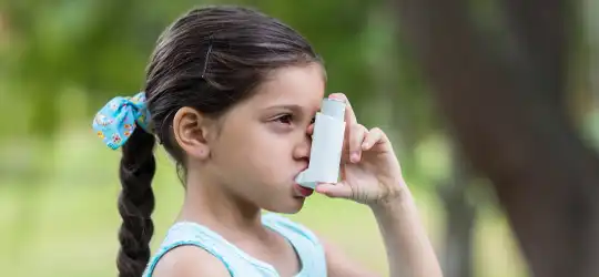 Girl using inhaler