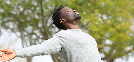 man taking deep breath