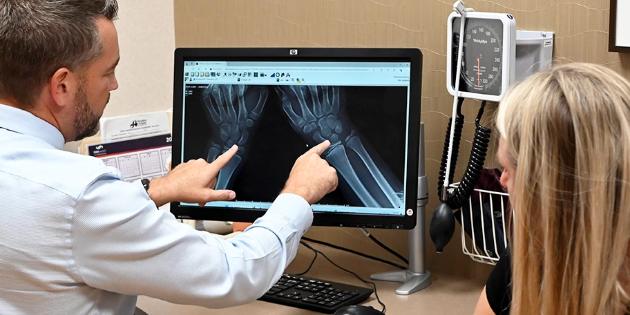 dr. roman explains wrist x-ray to patient
