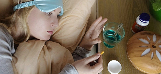 woman trying to sleep taking melatonin