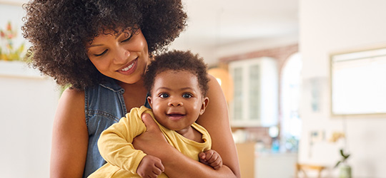 black mom holding baby