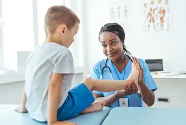 provider checking child's knee