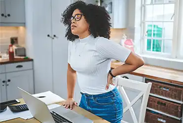 Woman clutching lower back in pain