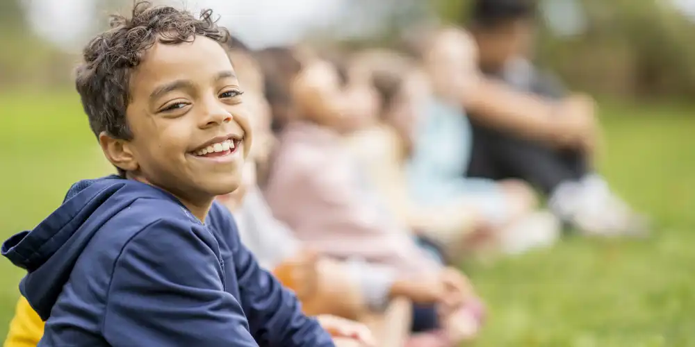 Kids sitting in grass