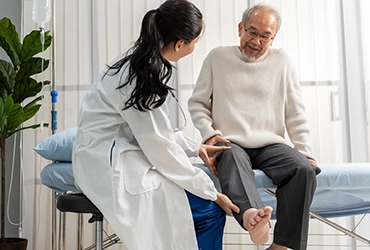 provider checking patient's knee pain and mobility