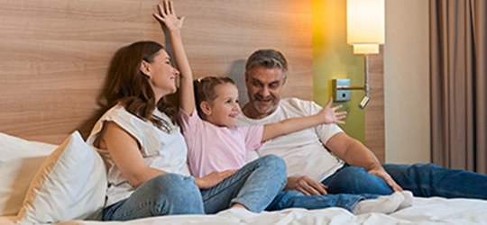 child mother and father in hotel room