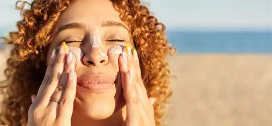 Woman applying sunscreen