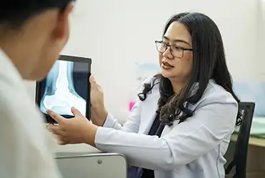 podiatrist showing patient x-ray of foot