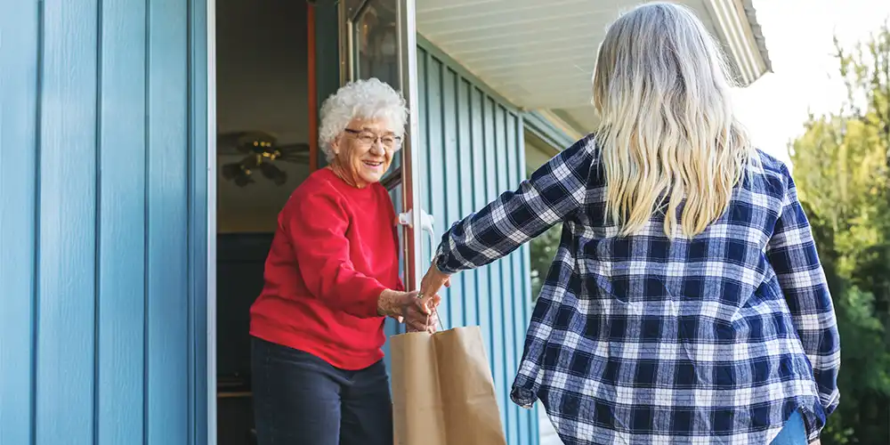 volunteer delivering meals on wheels meal