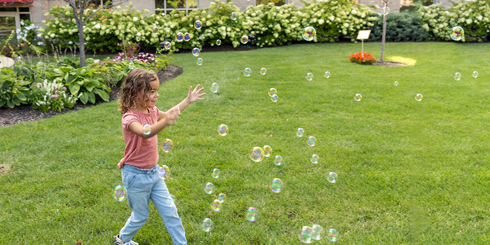 tranquility-healing-garden-young-girl-chasing-bubbles