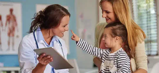 Child and mother smiling at provider