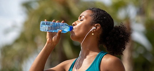 Woman drinking water.