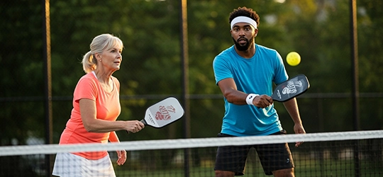 Two people playing pickleball.