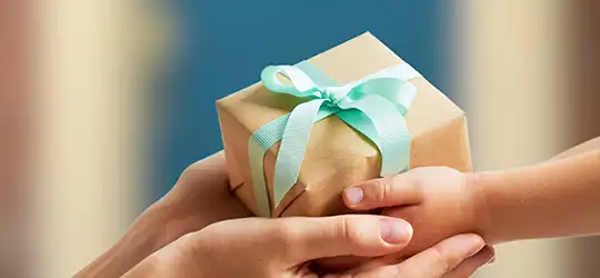 adult and child hands holding gift
