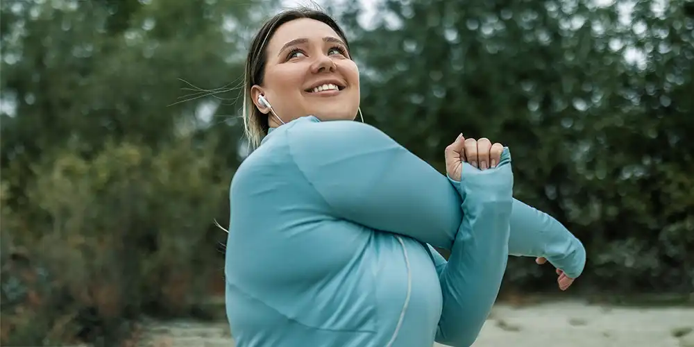 plus size woman stretching before jog