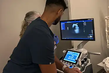 resident using ultrasound machine