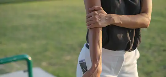 woman holding elbow