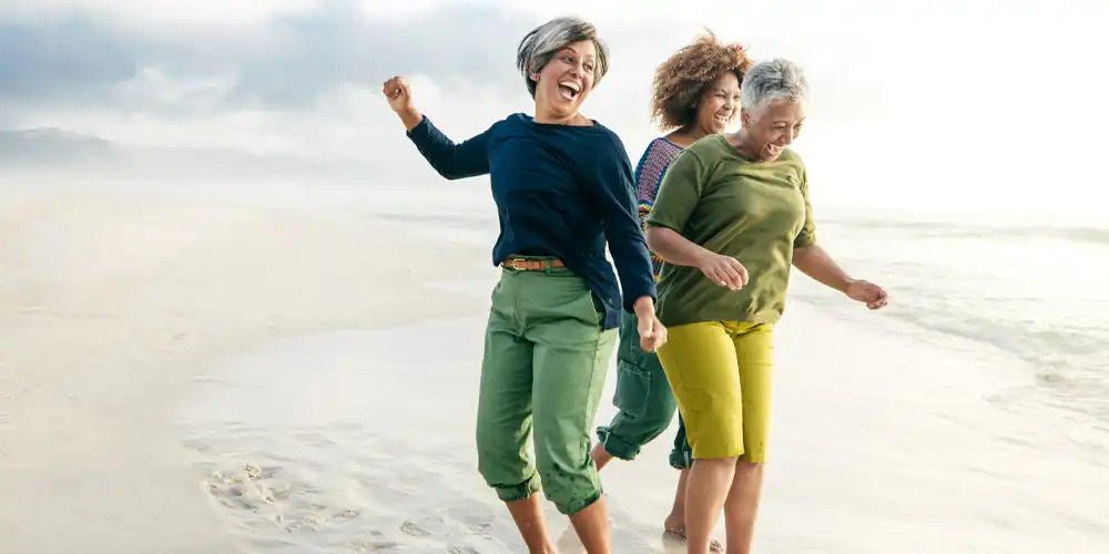 Women jumping in the sand