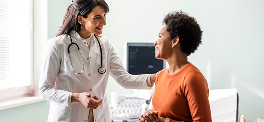 female doctor smiling at female patient